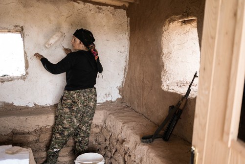 Siham Ali, de 40 anos,  faz guarda na entrada de JinWar e ajuda na construção